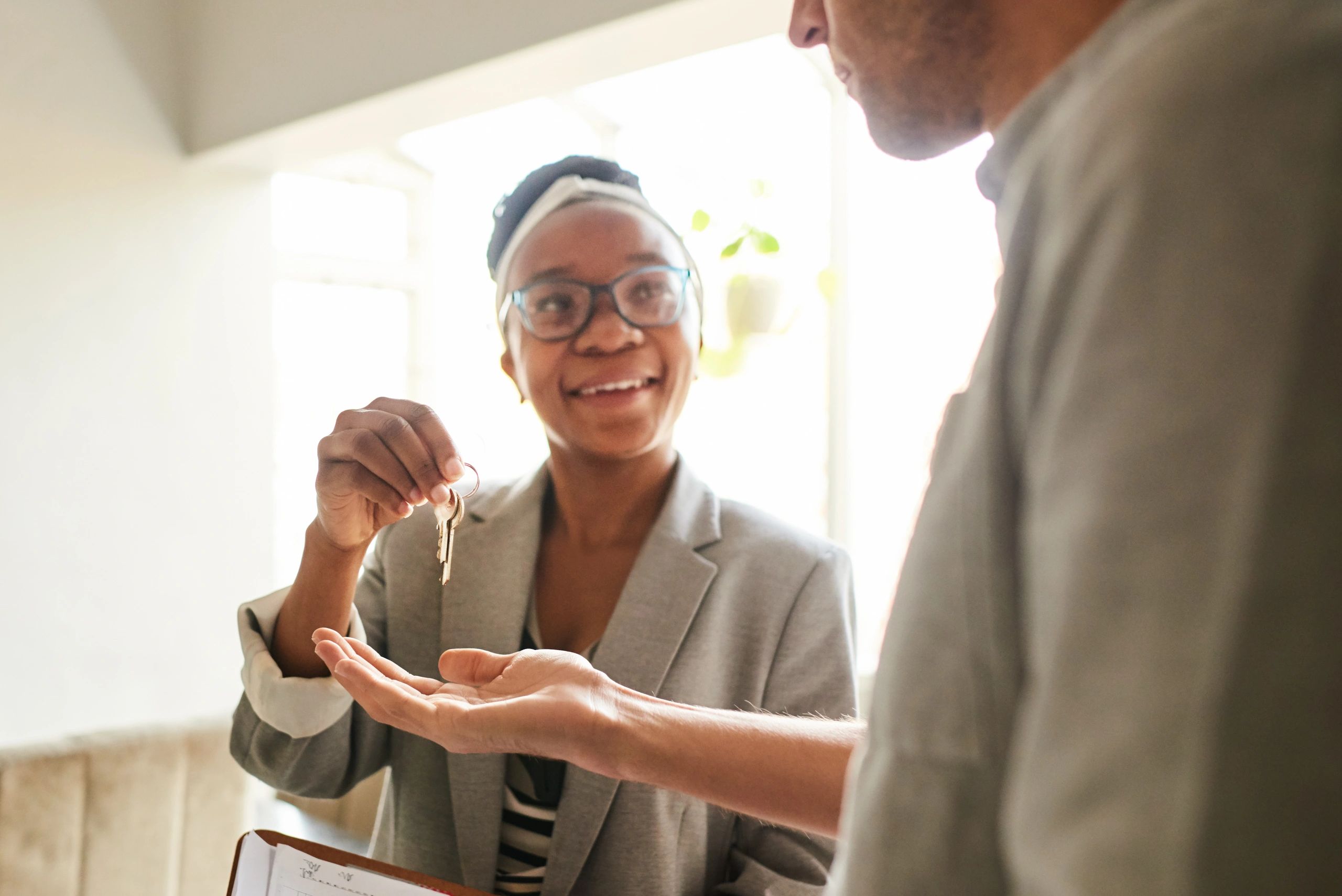 Real estate agent handing keys to a client