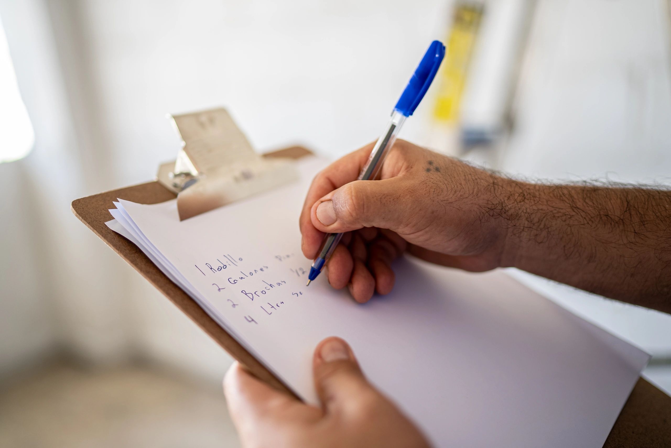 Assessor writing on a clipboard during an inspection