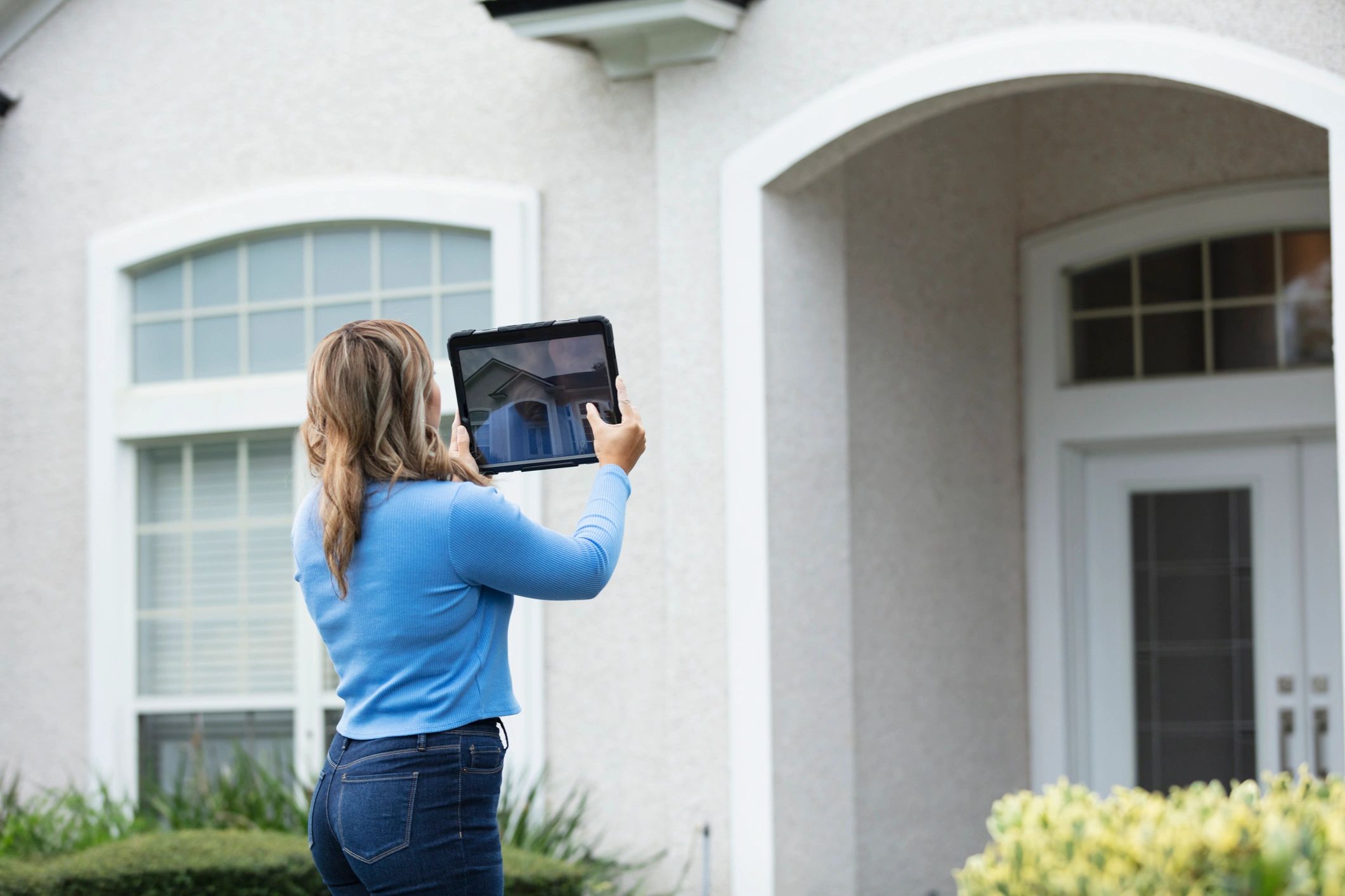Home inspector photographing a residential property